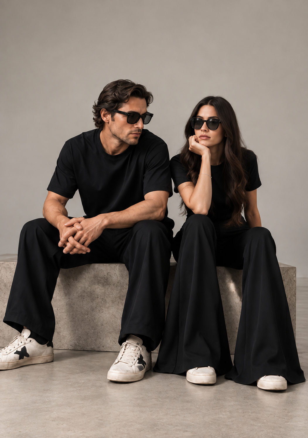 A man and a woman together in the all-black KŪRK uniform