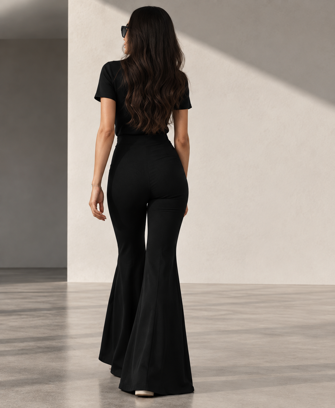 A woman wearing THE WOMEN'S PANT with the dramatic flare visible